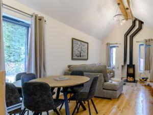 a living room with a table and chairs and a couch at Rinstone Lodge in Thornton Dale