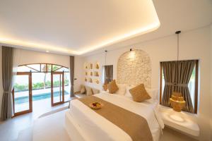 a bedroom with a large bed and a pool at Dianatara Villa by Dhananjaya Hospitality in Sukawati +32 photos