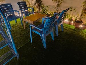 a group of blue chairs and a wooden table at Tatvamasi Homestay in New Delhi