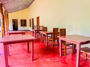 a group of tables and chairs in a room at Liyara Lodge Sigiriya in Sigiriya +54 photos