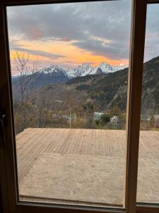 a view from a window of a mountain view at Les chalets Super Geants in Saint-François-Longchamp