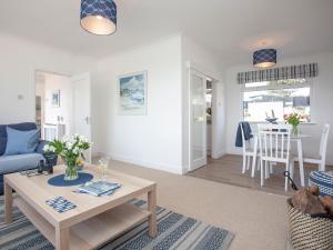 a living room with a couch and a table at Blue Horizon in Sidmouth