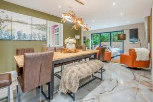 a dining room with a table and chairs at Palm Beach House in Mudeford