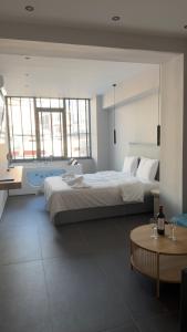 a bedroom with a large bed and a bath tub at Timeless luxury suites & SPA in Thessaloniki