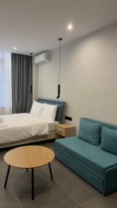 a hotel room with a bed and a couch at Timeless luxury suites & SPA in Thessaloniki