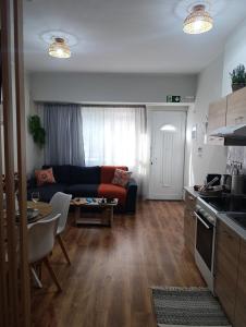 a kitchen and living room with a couch and a table at Studio35 in Athens