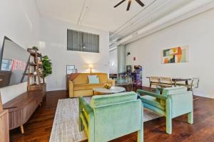 a living room with two chairs and a couch at 2BR Downtown Gem with Arcade games! - Sleeps 7 - Near Convention Center - Stadium in Indianapolis