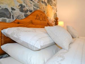 a bed with a wooden headboard and two white pillows at Sunrise in St Austell