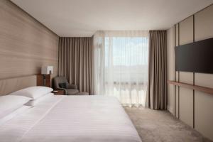 a hotel room with a bed and a large window at Lisbon Marriott Hotel in Lisbon