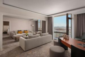 a large living room with couches and a table at Lisbon Marriott Hotel in Lisbon +149 photos