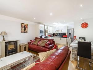 a living room with a couch and a fireplace at Cobble Cottage - Uk38973 in Whitby