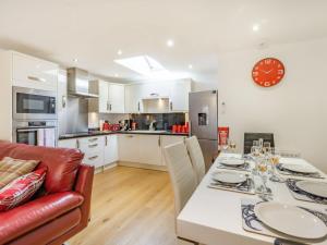 a kitchen and dining room with a table and chairs at Cobble Cottage - Uk38973 in Whitby