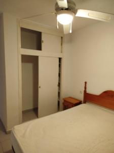 a bedroom with a bed and a ceiling fan at TorrelagunaVera in Palomares
