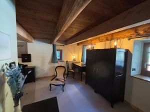 a living room with a desk and a table and chairs at Riverside Room Joseph in Pontboset