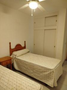 a bedroom with two beds and a closet at TorrelagunaVera in Palomares +3 photos