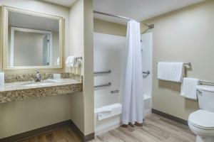 a bathroom with a toilet and a sink at TownePlace Suites Raleigh Cary/Weston Parkway in Cary +18 photos