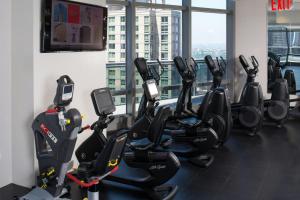 a gym with treadmills and elliptical machines at Courtyard by Marriott New York Manhattan/Central Park in New York