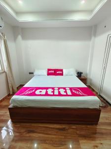 a large bed in a bedroom with a pink blanket at Atiti Signature room 109 , zero mile in Patna
