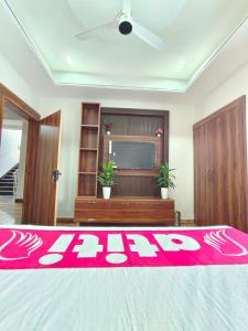 a living room with a red blanket on a bed at Atiti Signature room 109 , zero mile in Patna +1 photo