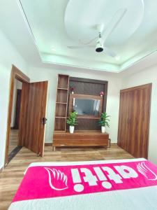 a room with two doors and a red rug at Atiti Signature room 109 , zero mile in Patna