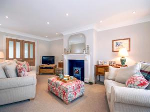 a living room with two couches and a fireplace at Haven View in Neyland