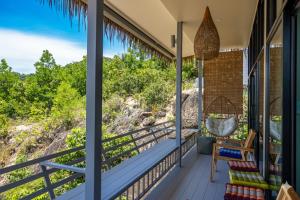 a balcony with a view of the ocean at Archie s Paradise View in Ko Phangan