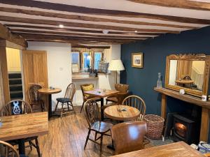 a restaurant with tables and chairs and a mirror at Coffee & Stays at Cartmel Square in Cartmel