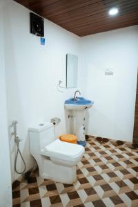 a bathroom with a toilet and a sink at Sameer beachfront Cottages in Canacona +71 photos