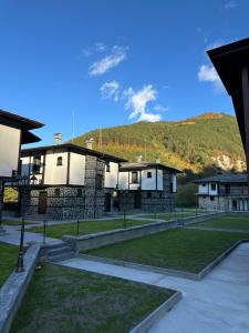 a group of buildings with a mountain in the background at Devin River in Devin