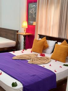 a bedroom with two beds with flowers on them at Mom's Homestay in Sigiriya
