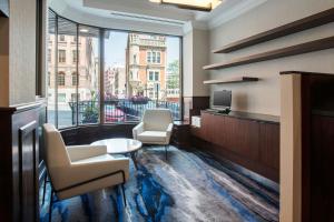 a room with two chairs and a table and a window at Fairfield Inn & Suites by Marriott Albany Downtown in Albany