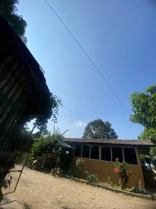 a house with flowers in front of it at Hotel Dobhan in Bharatpur