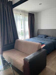 a bedroom with a bed and a couch and a chair at 02Nice room phuket town near Shopping Malls and Naka night market in Phuket Town +37 photos