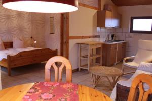 a kitchen and living room with a table and chairs at Weingut Loescher in Senheim