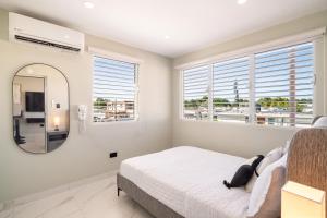 a bedroom with a bed and a large mirror at 2bedroom Lux house Isla Verde with Private Patio by PH in Carolina