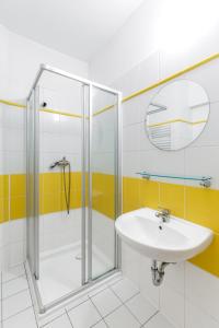 een badkamer met douche en wastafel bij Hotel CHOTOL in Horoměřice