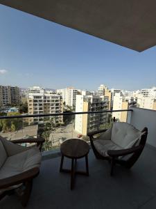 a balcony with two chairs and a table and a view at Riverside Life Residence in Iskele