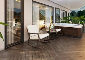 Zimmer mit einer Badewanne, Stühlen und einem Tisch in der Unterkunft L'amour Cruise Halong 2 in Hạ Long