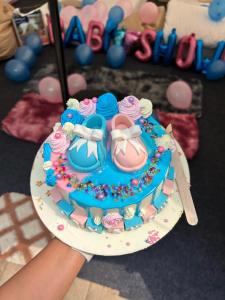 a person holding a birthday cake with cupcakes on it at Annapurna Nature Retreat, Namchi South Sikkim in Singtām