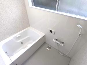 a white bathroom with a tub and a sink at Sakura House サクラハウス 高知駅から車で20分-豊かな自然を味わう山の隠れ家 in Kochi +30 photos