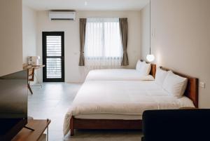 Ένα ή περισσότερα κρεβάτια σε δωμάτιο στο 日上微旅 stay & café