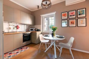 a kitchen with a table and chairs in a room at Casa KAI Ostia in Lido di Ostia +27 photos