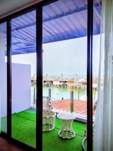 a room with a view of a balcony with a table at Q3 Inn in Semporna