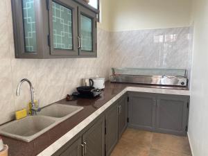 a kitchen with two sinks and a counter top at Belle Mare Apartment in Belle Mare