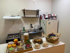 a kitchen with a refrigerator and a counter with food at Apartamento 03 São Brás COP30 in Belém