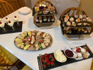 a table with many different types of food on it at Lily Rose Cottage in Lanercost