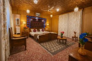 a bedroom with a bed and a chair in it at halloween palace in Srinagar