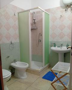 a bathroom with a shower and a toilet and a sink at Sicilia Bedda Casa Vacanze in Lascari