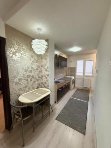 a kitchen with a table and a dining room at Apartament Densia in Craiova close to the center in Craiova