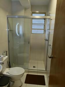 a bathroom with a toilet and a glass shower at Apartamento Amplio Cerca de Todo con Seguridad y con Todas las Comodidades de un Hospedaje Renovado y Totalmente Equipado, ademas Tene Wi-Fi de Alta Velocidad in Caracas